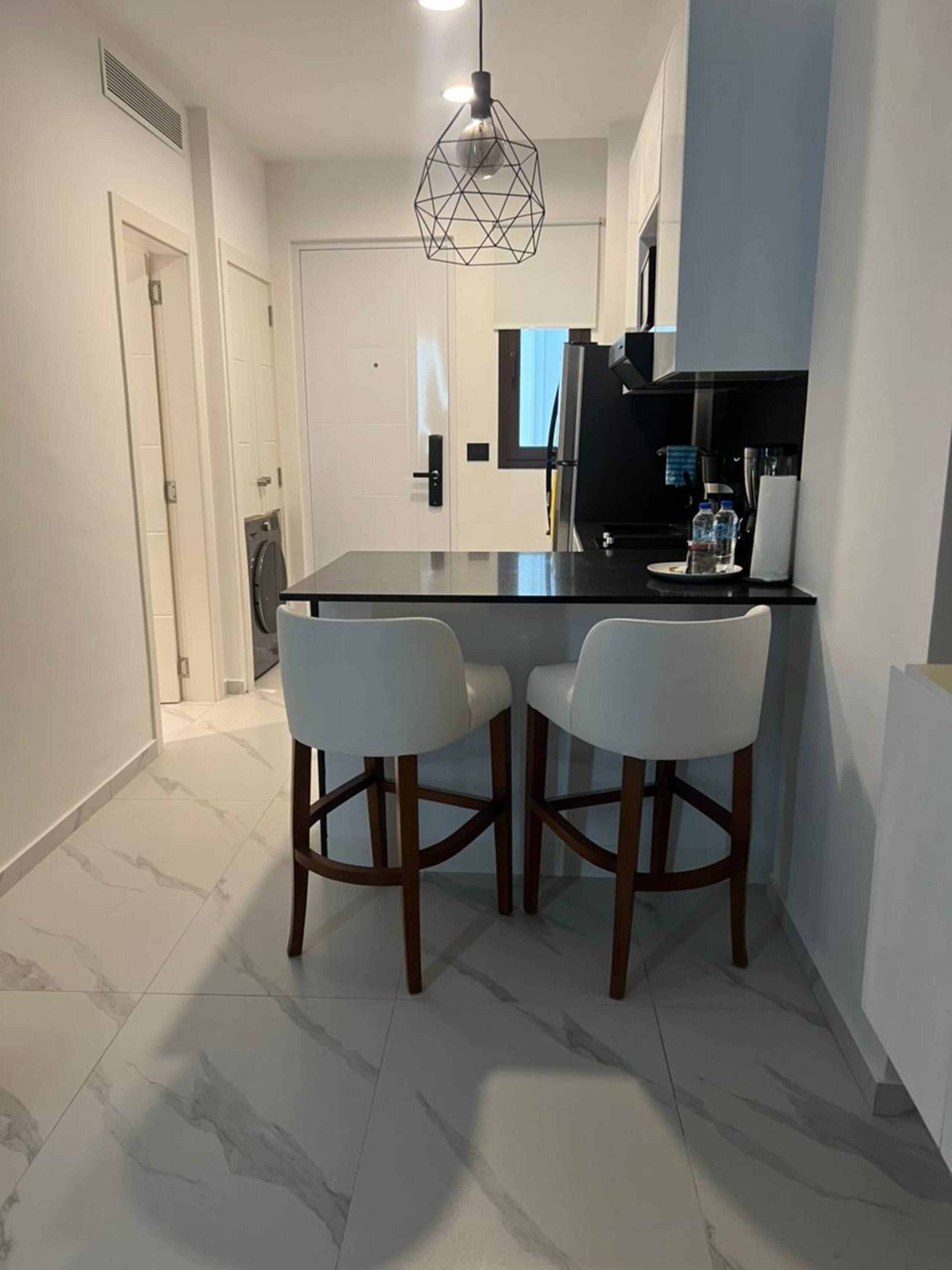 Kitchen with breakfast bar and two stools